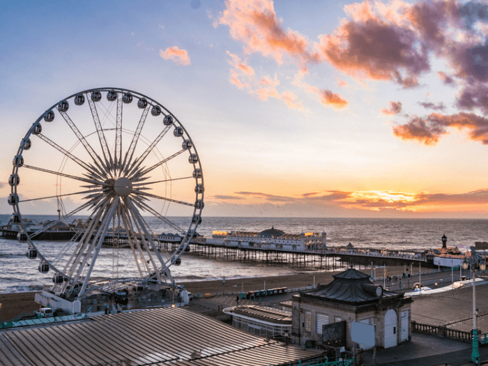View of the Victorian Brighton Pier and the Brighton wheel at sunset.