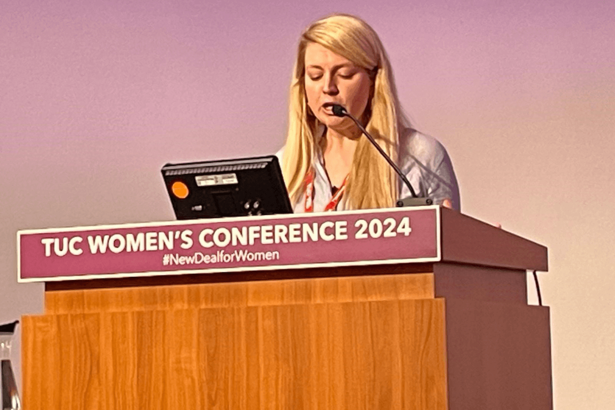 MU member Hailey Willington speaking on a podium at TUC Women's Conference