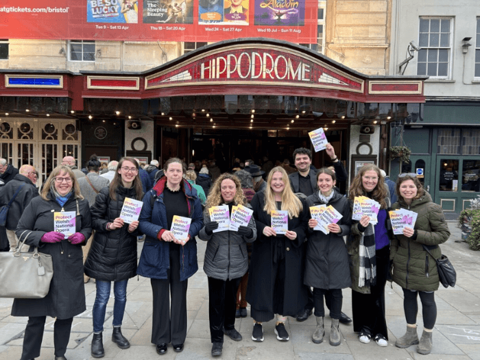 Members of the WNO orchestra standing outside the Bristol Hippodrome with leaflets from a demo on 27 April 2024.