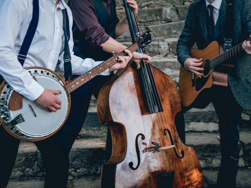 Photo of a trio of musicians, a banjo player, a double bass player and an acoustic guitarist.