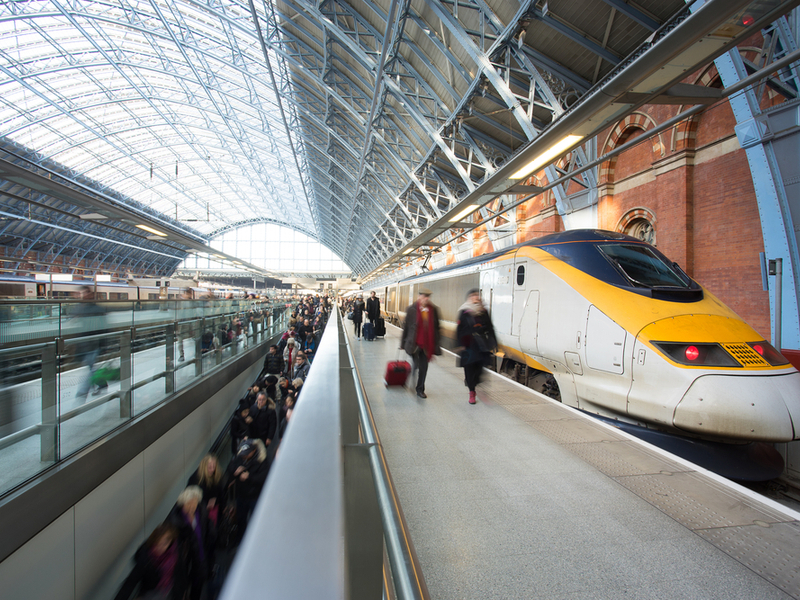 Train waits at busy st Pancras train station as passengers travel