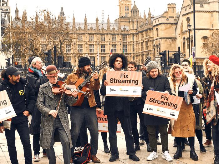Musician protesters with Fix Streaming plackards