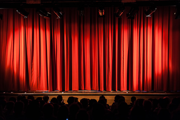 A red curtain closed across a stage.