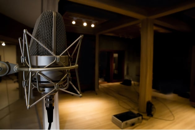 Photograph of an empty recording studio in semi darkness.