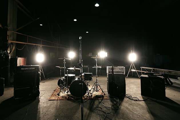 Empty stage with music instruments and lights on