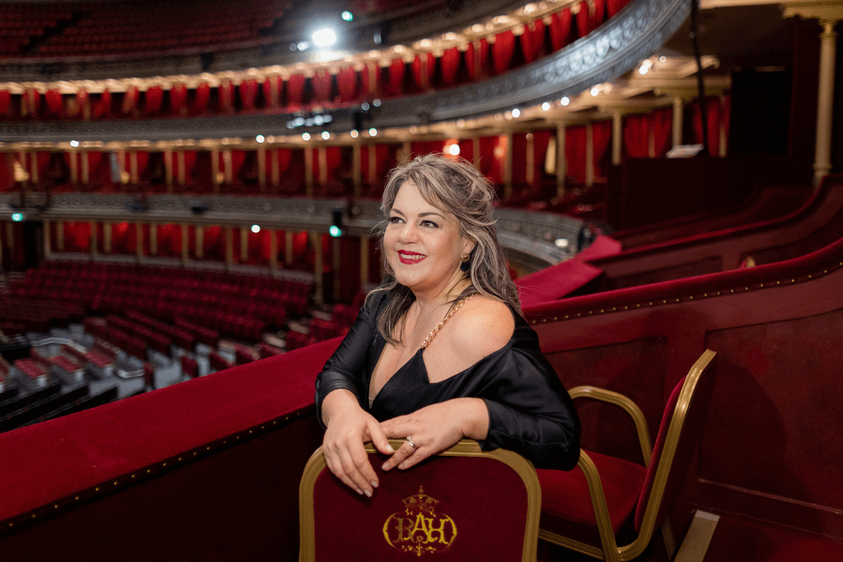 Gabriella Di Lacci sat smiling in an empty theatre.