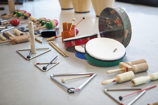 Photograph of assorted instrument lining up to be played in a classroom.
