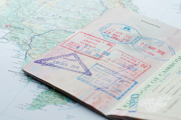 Photograph of open passport on top of map