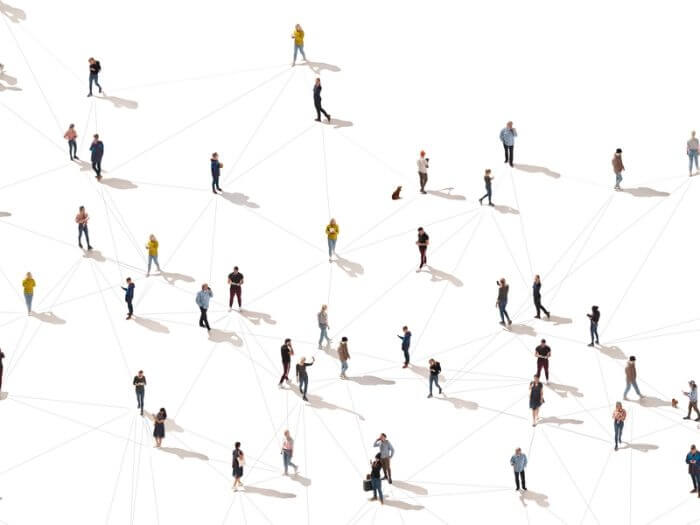 Aerial view of a diverse crowd of people against a white background, connected by lines, representing connection and networking concepts.